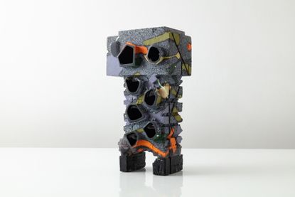 Abstract glass sculpture made of geometric elements in blue, gray, orange and green by American artist Thaddaeus Wolfe