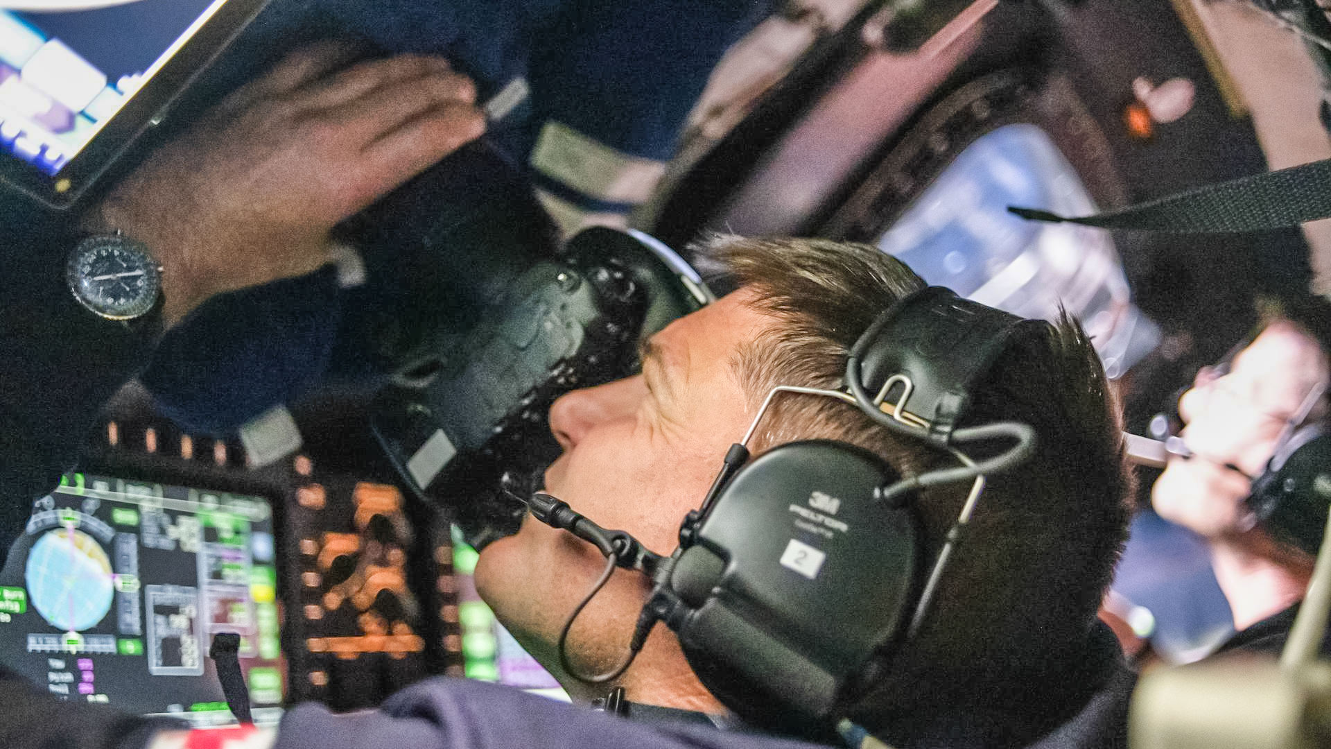 Canadian Space Agency astronaut and Artemis II Mission Specialist Jeremy Hansen is seen taking images through the Orion spacecraft window with Nikon D5