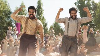 Ram Charan and N.T. Rama Rao Jr. both pumping their fists while dancing during Naatu Naatu in RRR.