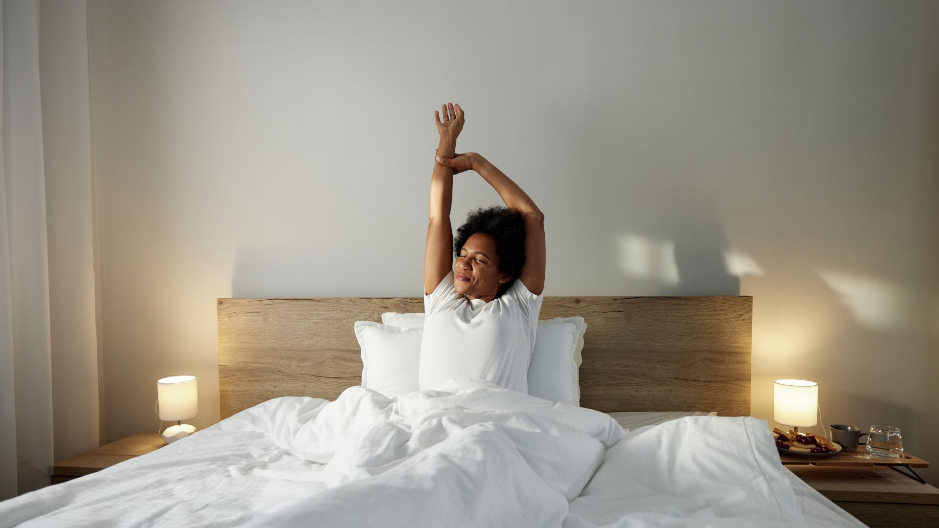 Woman waking up in the morning, stretching arms