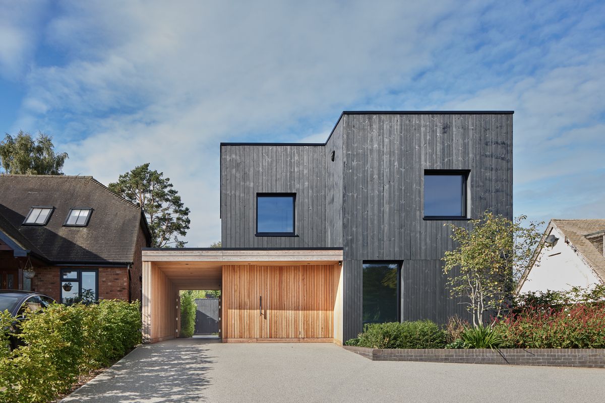 A modern home with a timber clad porch