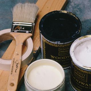 wooden paint brush paint can and tape