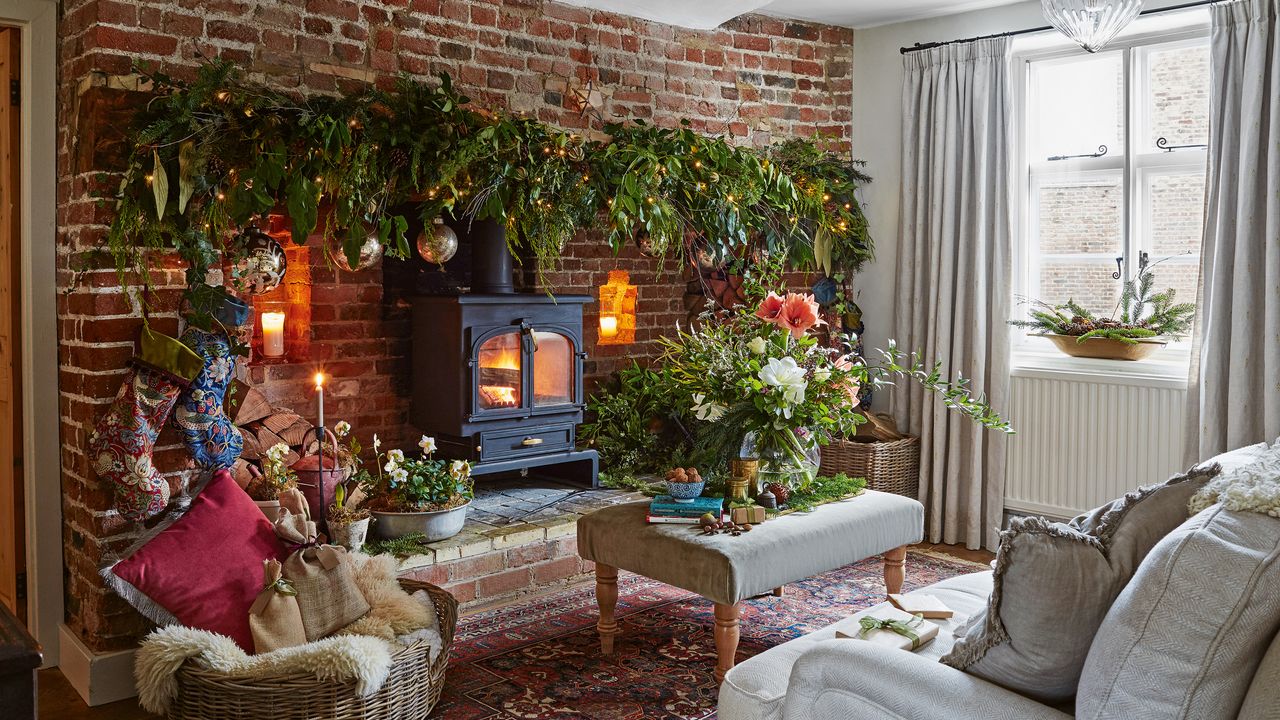 a living room with large brickwork fireplace surround with a woodburning stove and a lush garland and festive flowers