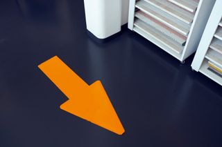 Orange arrow on blue floor