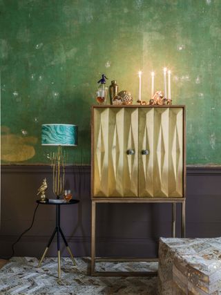 Glamorous gold sideboard with candles by Graham & Green