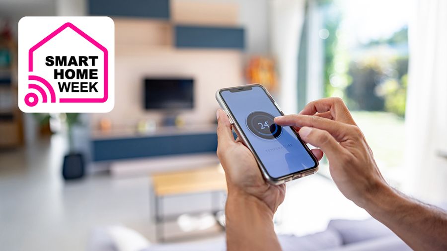 Person using smartphone to control thermostat in living room