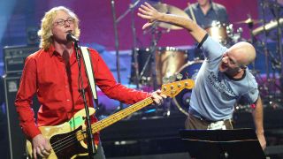 R.E.M., with bass player Mike Mills (L) and singer Michael Stipe, perform on "The Tonight Show with Jay Leno" at the NBC Studios on October 28, 2003 in Burbank, California.