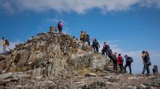 Hikers queuing to reach the top of Mount Snowdon