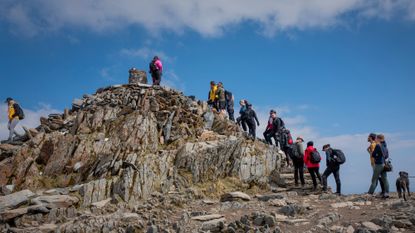 Hikers queuing to reach the top of Mount Snowdon