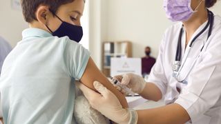 A child gets the COVID-19 vaccine.