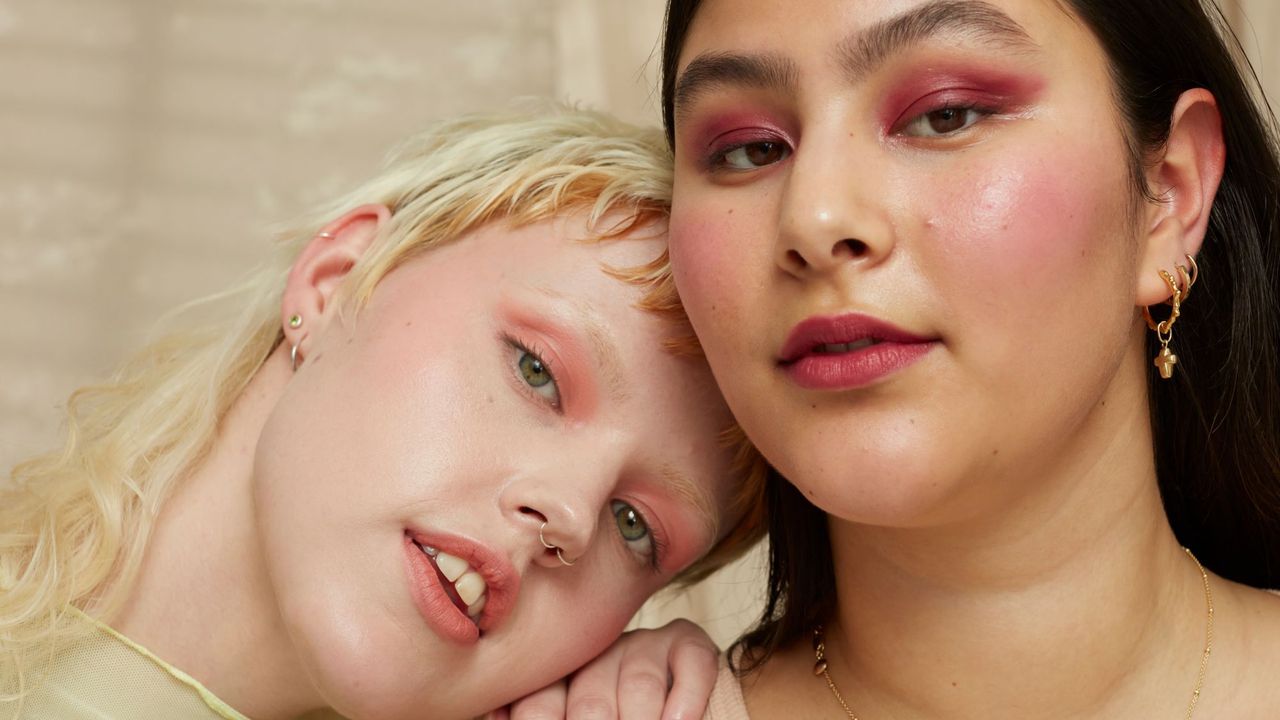 Two models wearing colourful The Body Shop make-up