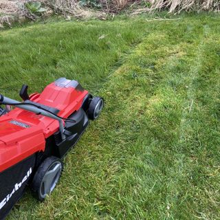 Einhell 18/30 Li Cordless lawn mower cutting a lawn