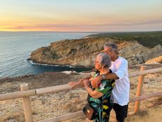 Elderly people admire the sunset in front of the sea