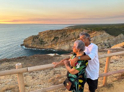 Elderly people admire the sunset in front of the sea