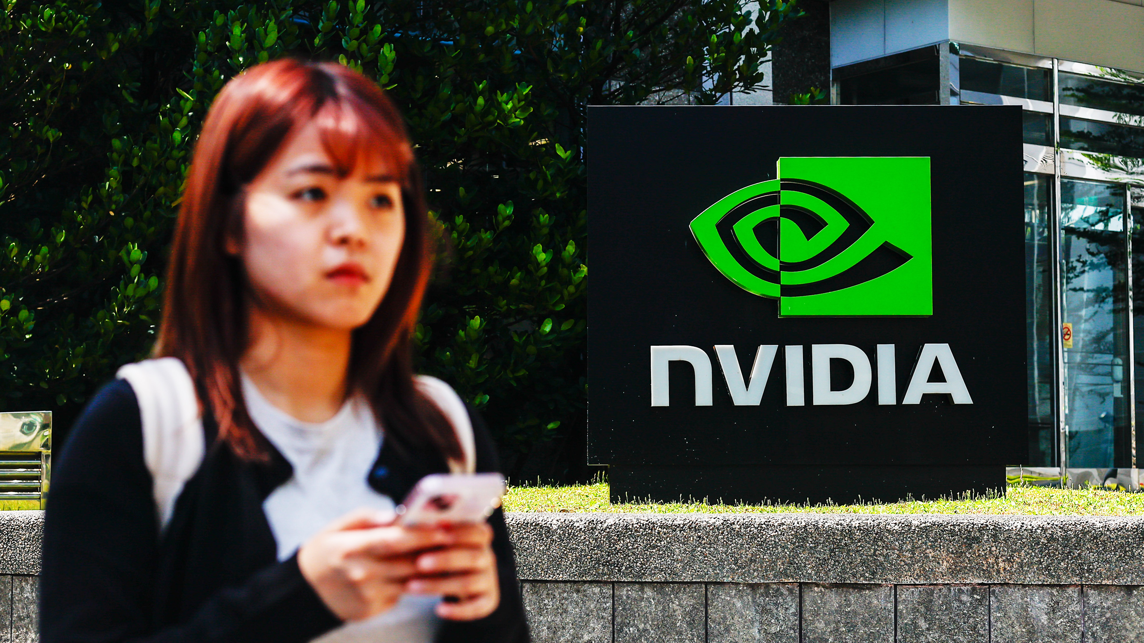 TAIPEI, TAIWAN - APRIL 16: The logo of NVIDIA, an American tech company which designs and supplies GPUs, APIs, and Artificial Intelligence (AI) software and hardware, in Taipei, Taiwan, on April 16, 2025. The United States President Donald Trump&#039;s administration has confirmed that tariffs on semiconductors and some other technology products will &#039;take place in the very near future&#039;. With tariffs and export restrictions expected to be implemented by the American government, electronic products such as iPhone, smartphones, tablet, computer and other digital devices requiring advanced microchips, as well as such global supply chain are likely to be affected. (Photo by Daniel Ceng/Anadolu via Getty Images)