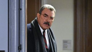 Frank in the doorway of an office on Blue Bloods before it was canceled, glasses on.