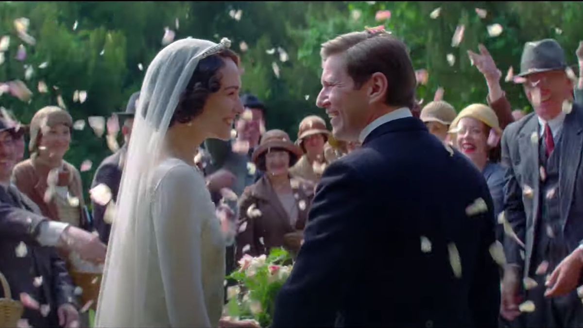 Tuppence Middleton and Allen Leech smile surrounded by flower petals at their wedding in Downton Abbey: A New Era.