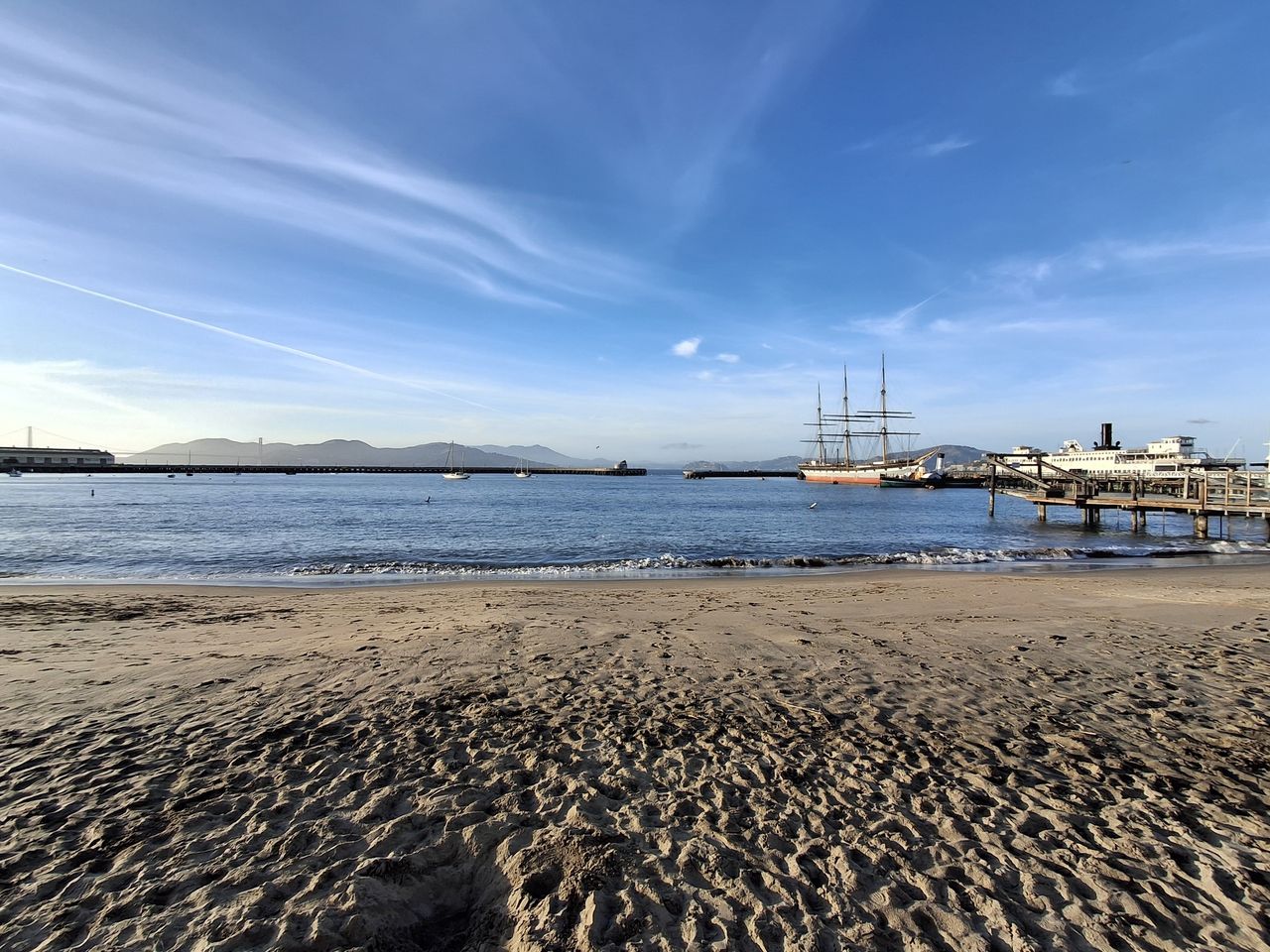 ultrawide photo of beach scene with tall ship in background shot on Galaxy A35