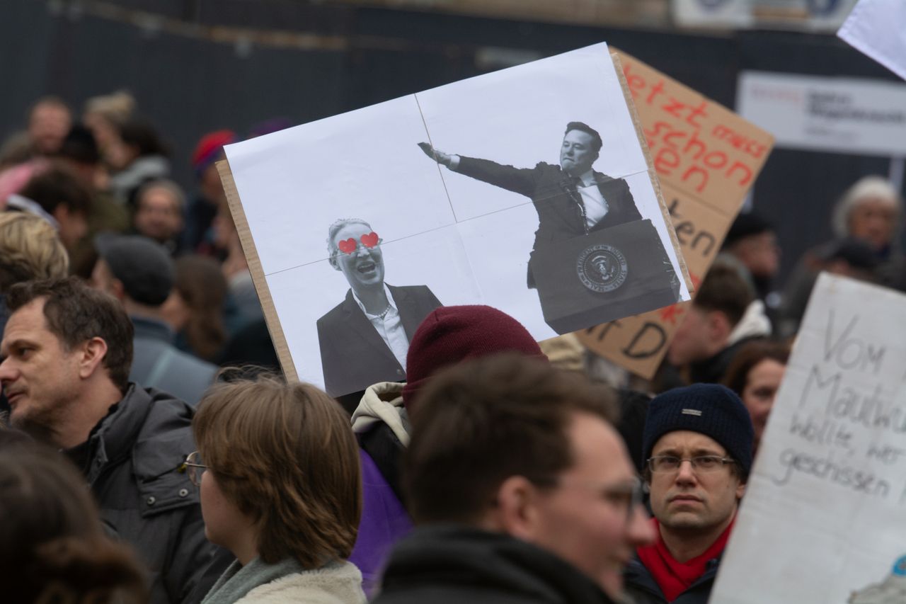 A sign of Elon Musk&#039;s Nazi salute and AFD leader Alice Weidel is seen as thousands of people take part in a protest against the AFD party at Heumarkt Square in Cologne, Germany, on January 25, 2025, ahead of the German election (Photo by Ying Tang/NurPhoto via Getty Images).