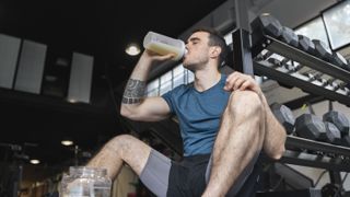 Man drinking protein shake at gym