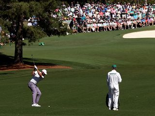 Scottie Scheffler playing a shot at Augusta National in The Masters