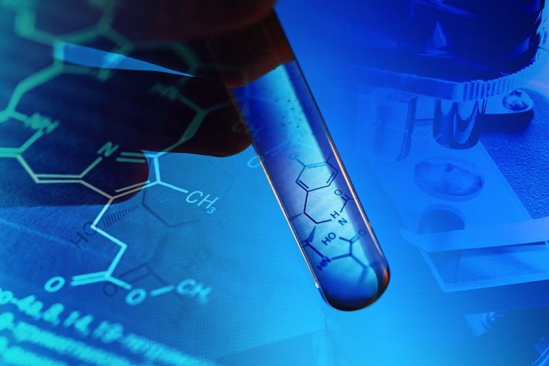 An image of a test tube with a chemical formula inside it