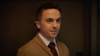 Frankie Muniz in Renner looking at someone uncomfortably in a hallway.