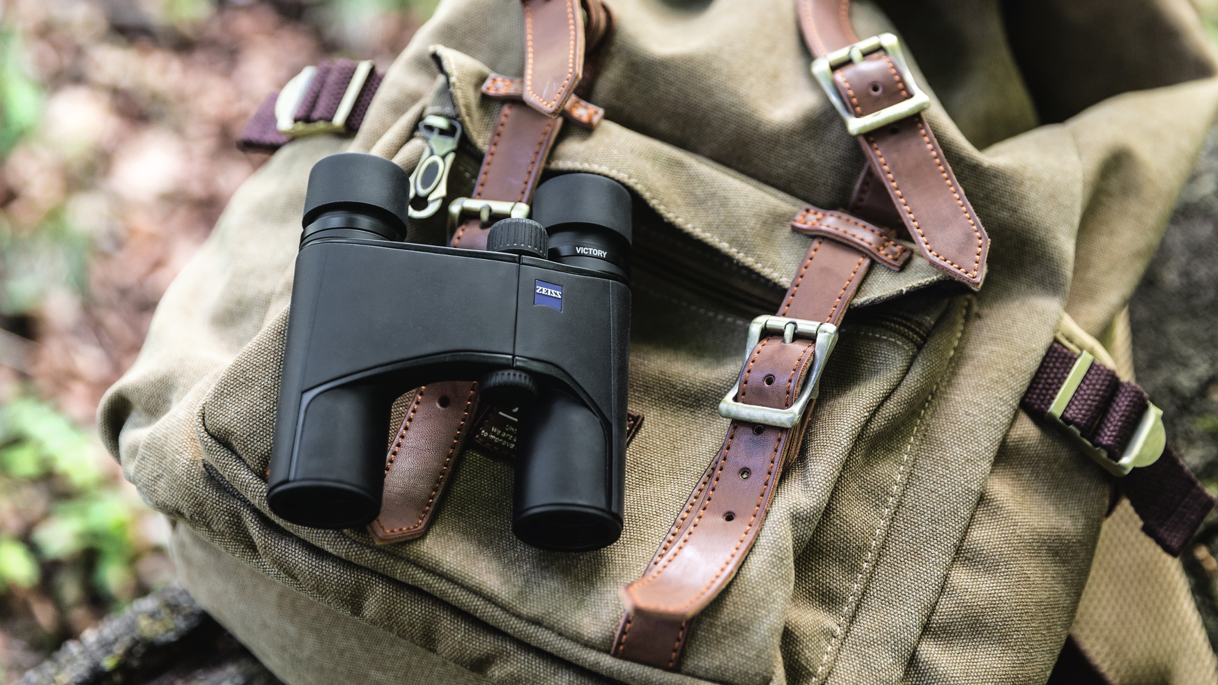 Zeiss Victory Pocket binoculars balanced on a rucksack on the ground outdoors