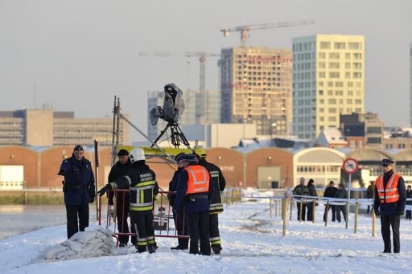 Police dispose of a WWII-era grenade discovered at the race venue, delaying the start of the men's event.