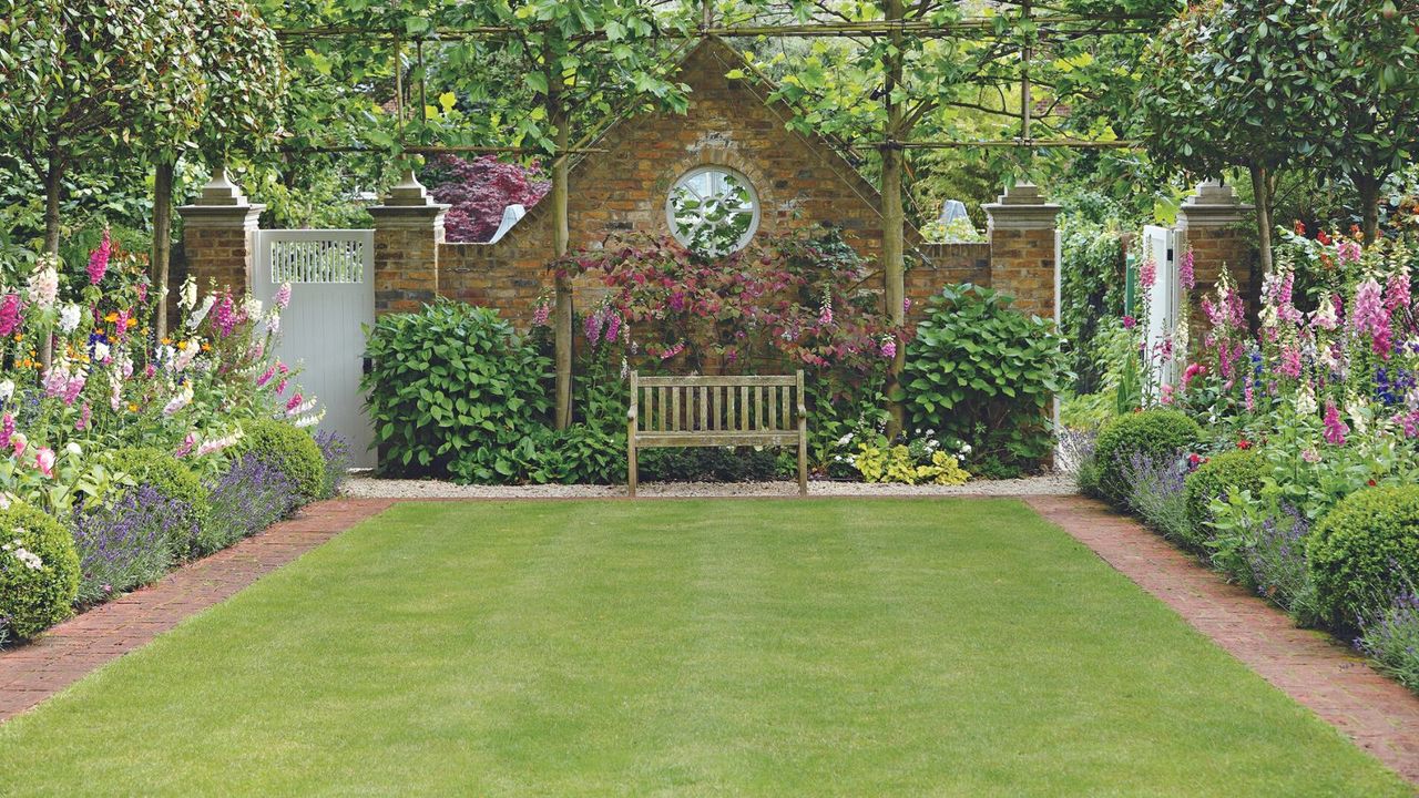 lawn surrounded by flower beds in a garden