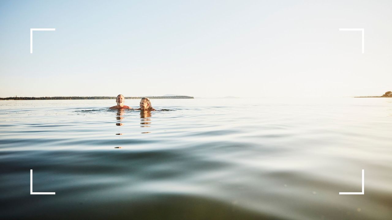 Man and woman swimming in the sea on holiday in the summer, representing the benefits of swimming in the sea