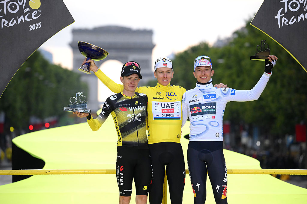 PARIS - CHAMPS-ELYSEES, FRANCE - JULY 27: (L-R) Jonas Vingegaard of Denmark and Team Visma | Lease a Bike on second place, race winner Tadej Pogacar of Slovenia and UAE Team Emirates - XRG - Yellow leader jersey and Florian Lipowitz of Germany and Team Red Bull - BORA - hansgrohe on third place pose on the podium ceremony after the 112th Tour de France 2025, Stage 21 a 132.3km stage from Mantes-la-Ville to Paris - Champs-Elysees / #UCIWT / on July 27, 2025 in Paris - Champs-Elysees, France. (Photo by Bernard Papon - Pool/Getty Images)