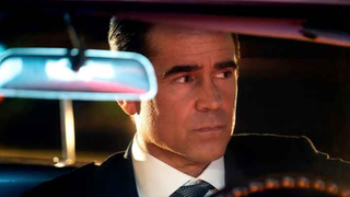 Colin Farrell as detective John Sugar, wearing a suit and sitting in a car whilst looking pensive in new show "Sugar"