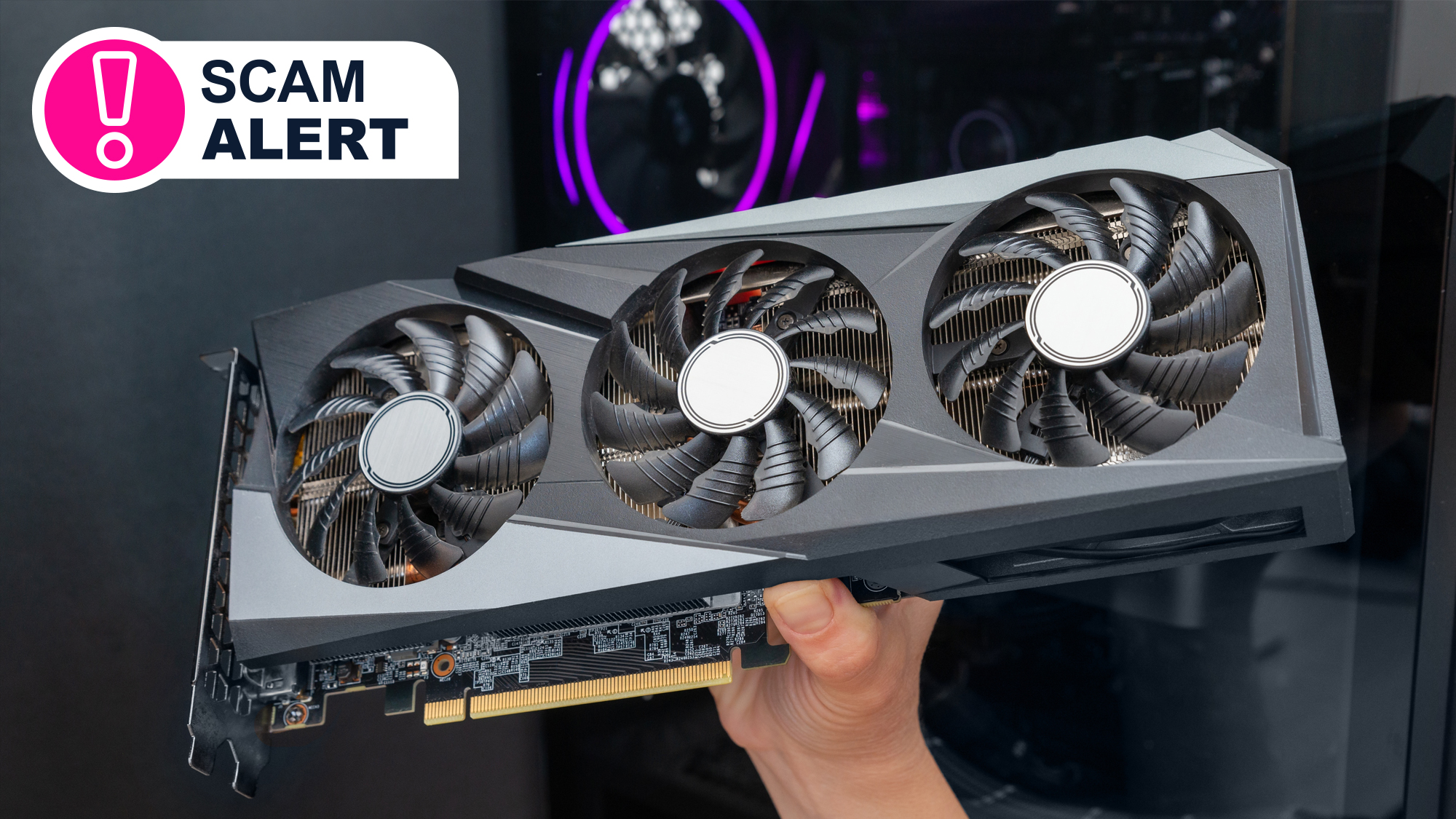 A hand holding a large graphics card