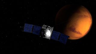 MAVEN, NASA's newest Mars orbiter, is shown near the Red Planet in this artist's illustration. The spaceraft, which launched in November 2013, will arrive at Mars on Sept. 21, 2014.