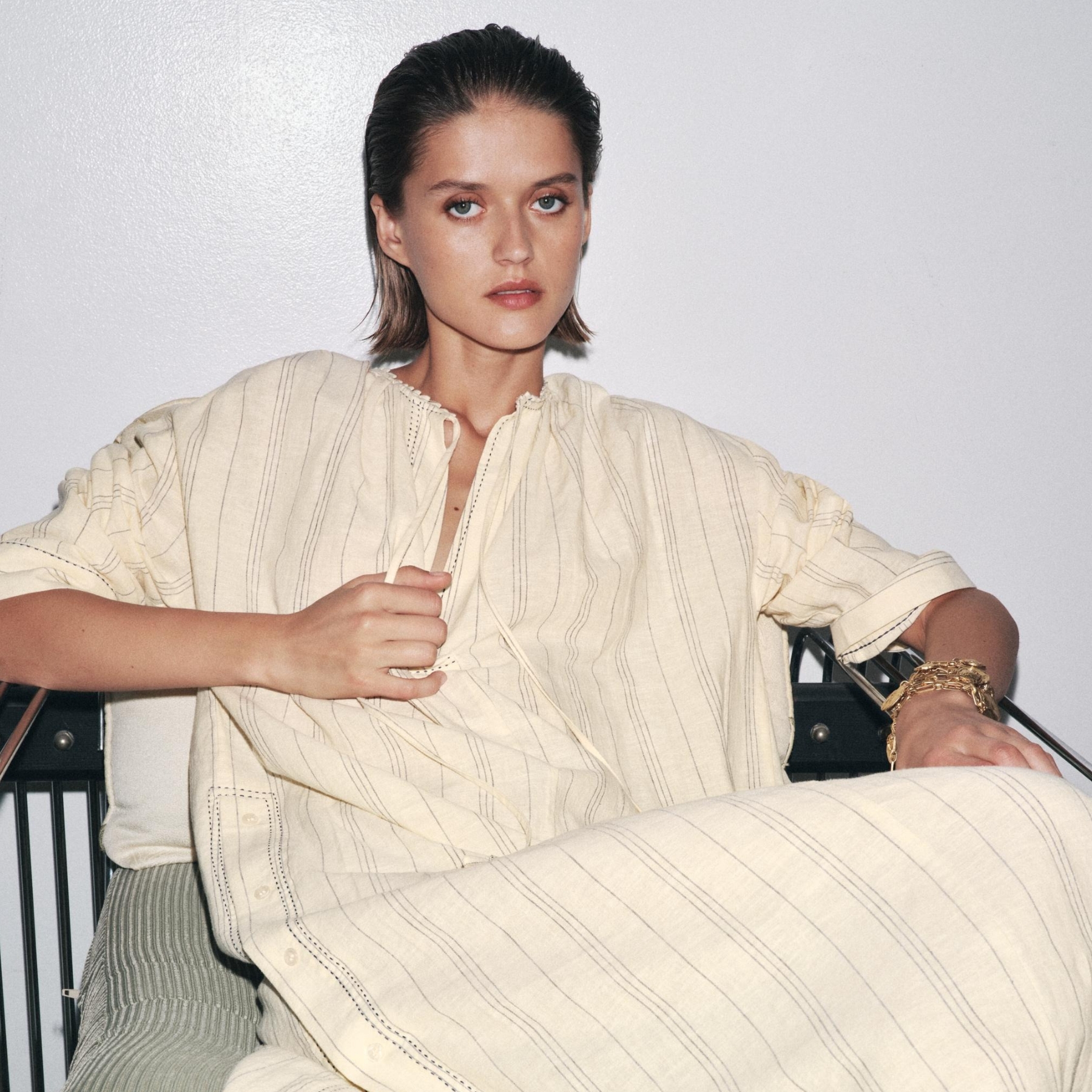 Model wearing a cream striped tunic dress.