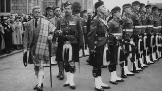 King Edward VIII (1894 - 1972) inspects a Scottish regiment at Balmoral. Queen Victoria's husband, Prince Albert, purchased Balmoral Castle in 1846, and the small castle which stood in the 7,000 hectare wooded estate was redeveloped in the 1850s.The granite building was designed by Aberdeen architect William Smith with suggestions from Albert himself, who decided the interior decoration should represent a Highland shooting box with tartan or thistle chintzes, and walls decorated with trophies and weapons. Queen Victoria often visited the Highlands with her family, especially after Albertfs death in 1861, and Balmoral is still a popular retreat for the present royal family.