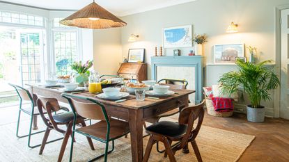 dining room with wood table and chairs and a blue fireplace