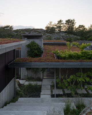 Cabin Lillesand, a norwegian summer house out of wood and its timber interior looking out to waterside nature views through large windows