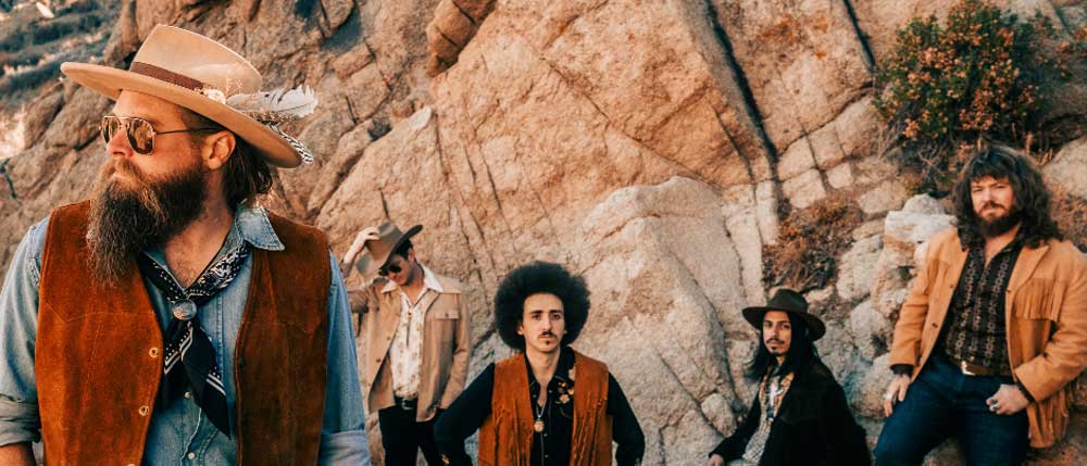 Robert Jon & The Wreck posing in a canyon