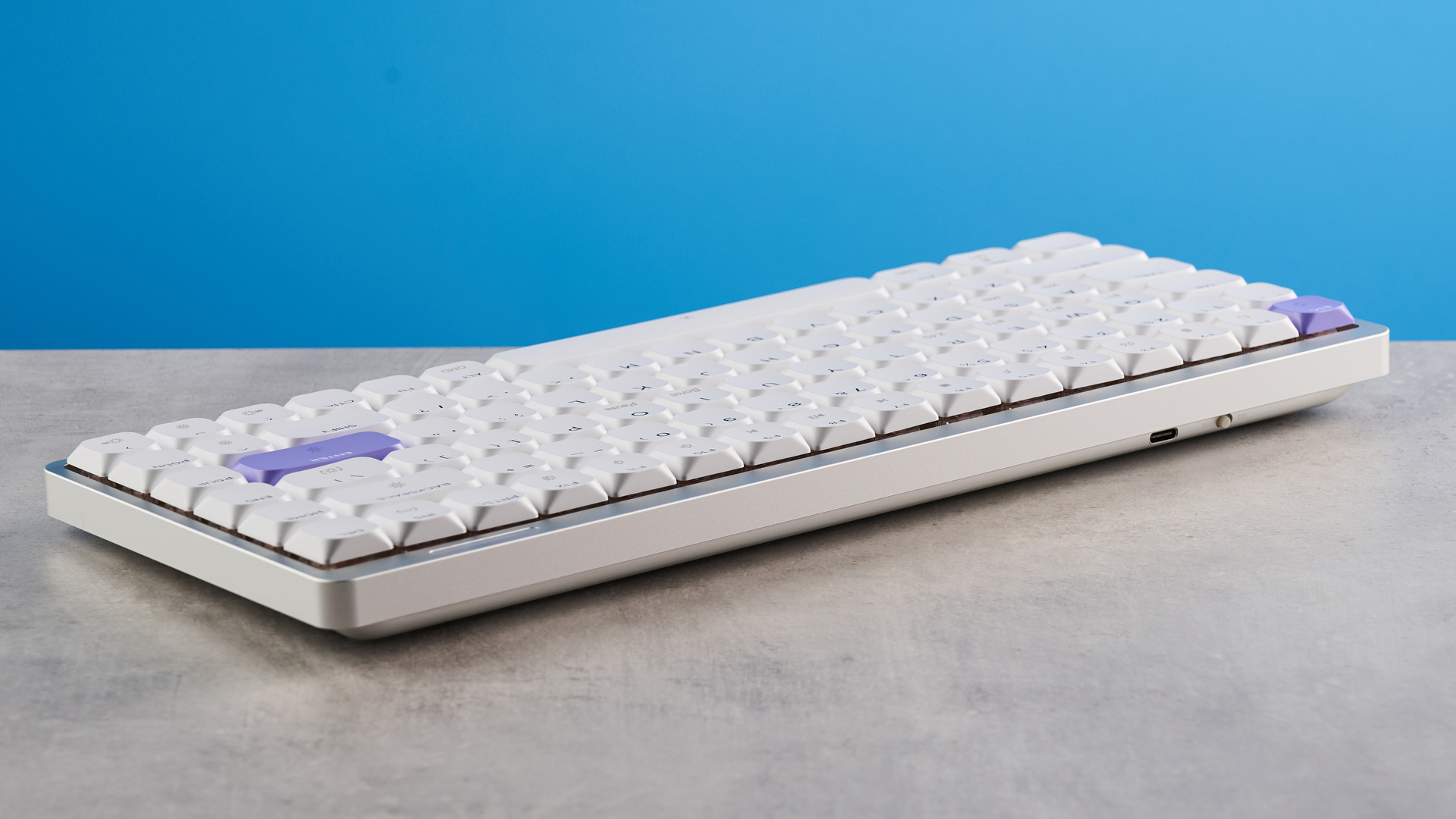A white and purple Epomaker Luma84 low-profile mechanical keyboard