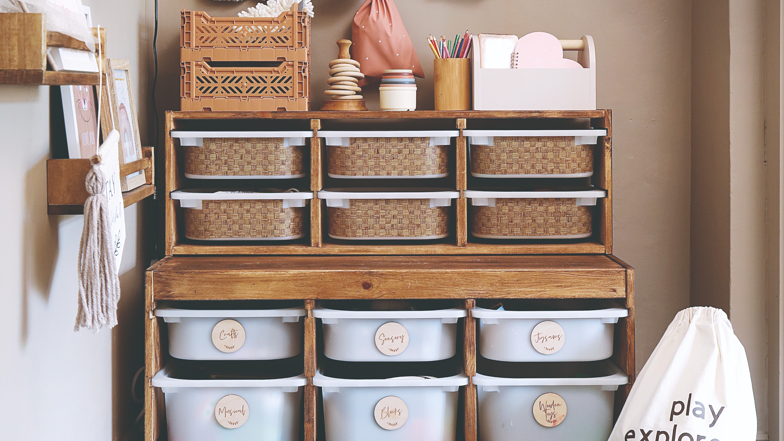A light brown-painted playroom with the IKEA TROFAST storage system customised with labels and stickers