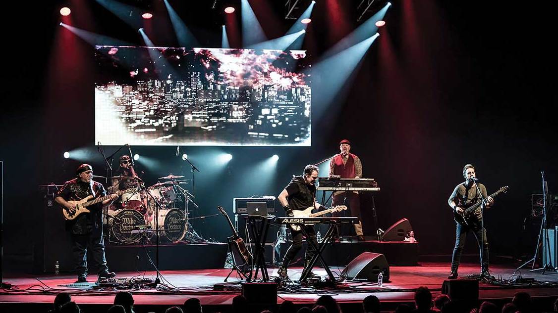 Neal Morse Band on stage with a video screen behind them