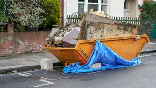 Full skip outside old house