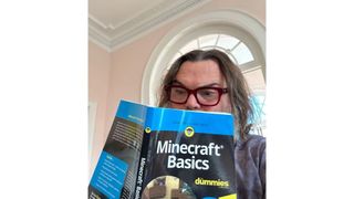 Image of Jack Black reading a "Minecraft Basics" book.