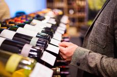 man choosing wine in a shop