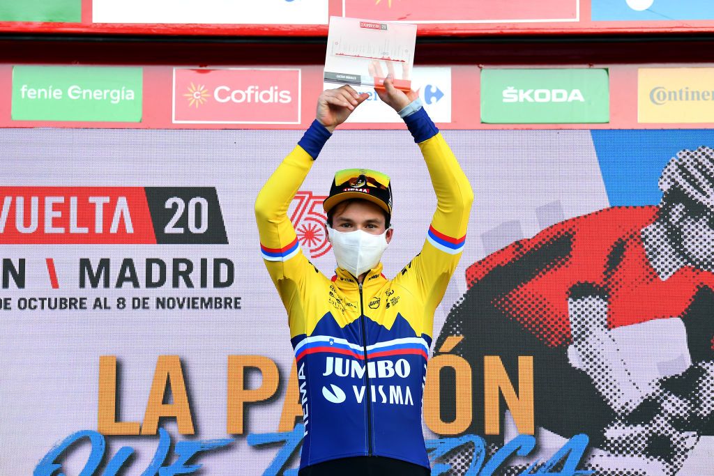 SUANCES SPAIN OCTOBER 30 Podium Primoz Roglic of Slovenia and Team Jumbo Visma Celebration Mask Covid safety measures Trophy during the 75th Tour of Spain 2020 Stage 10 a 185km stage from Castro Urdiales to Suances lavuelta LaVuelta20 La Vuelta on October 30 2020 in Suances Spain Photo by Justin SetterfieldGetty Images