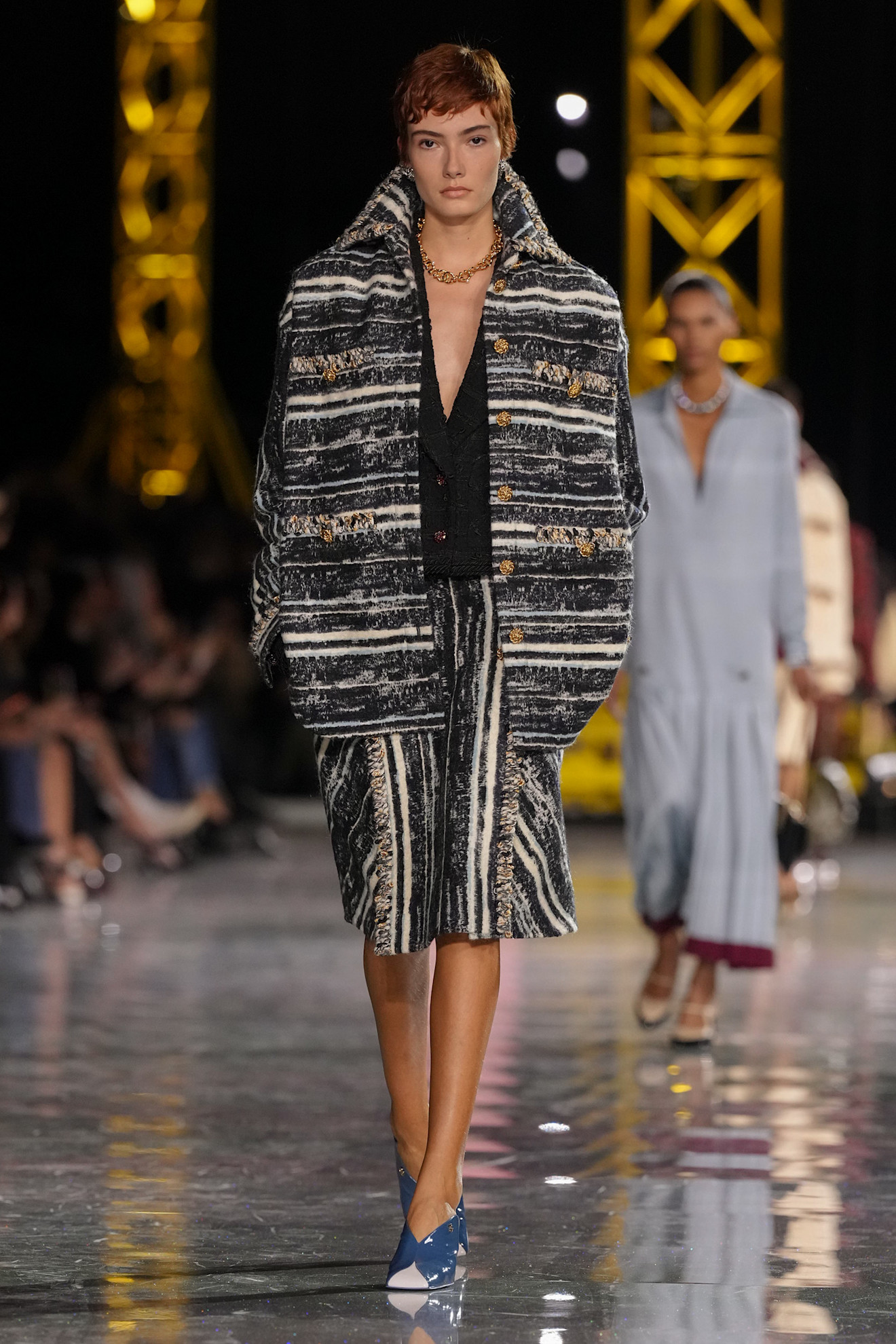 A model at the Chanel show wearing blue shoes.