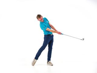 Golf Monthly Top 50 Coach Tom Motley demonstrating the post-impact position in the golf swing