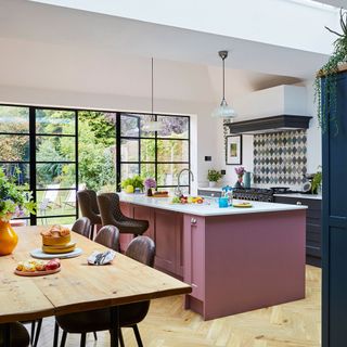 Kitchen extension with colourful island and Crittall-style doors to the garden